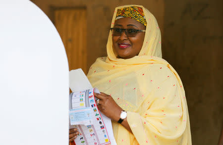 Nigerian President Muhammadu Buhari's wife Aisha Buhari holds a voting ballot as she attends Nigeria's presidential election at a polling station in Daura, Katsina State, Nigeria, February 23, 2019. REUTERS/Afolabi Sotunde