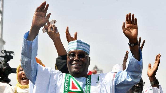 Peoples Democratic Party (PDP) Atiku Abubakar with his hands raised during a campaign rally in Kano, northwest Nigeria