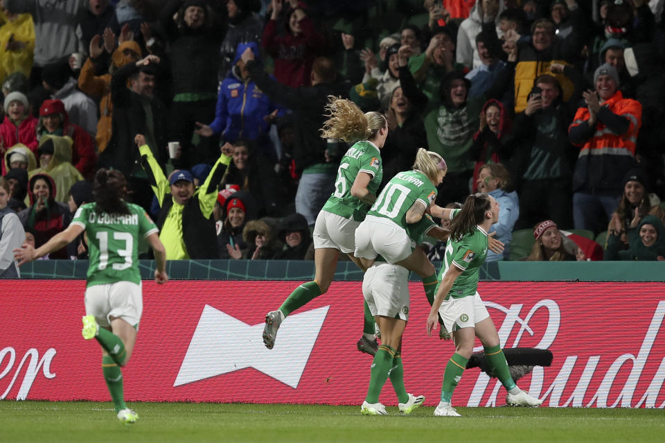 Ireland's Katie McCabe celebrates with teammates after scoring the opening goal from a corner during the Women's World Cup Group B soccer match between Canada and Ireland in Perth, Australia, Wednesday, July 26, 2023. (AP Photo/Gary Day)