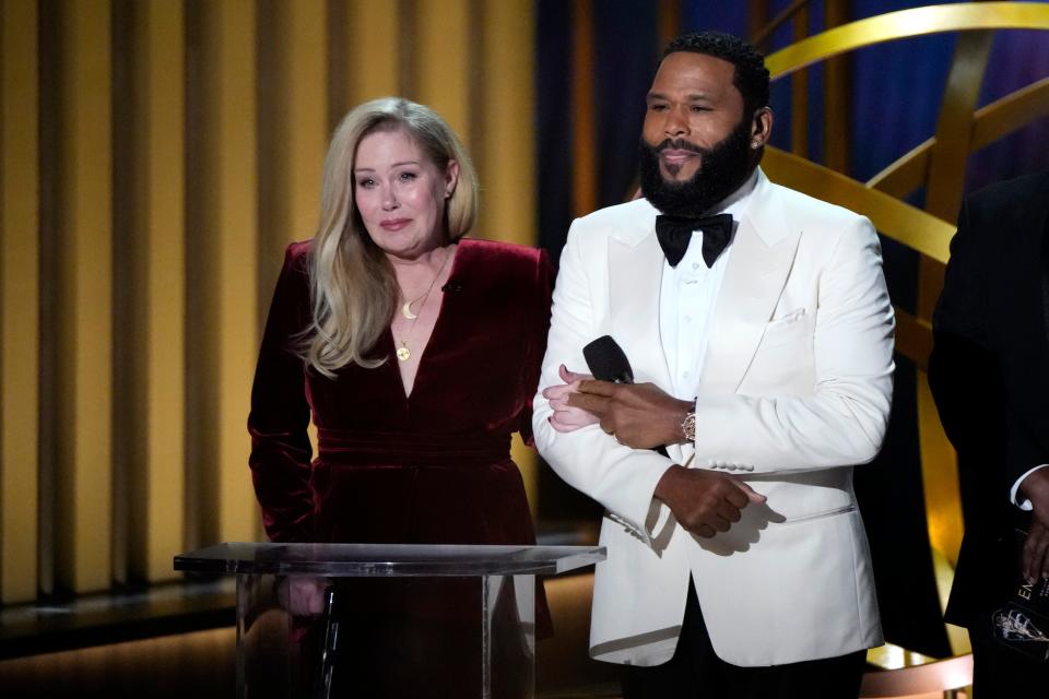 Emmys host Anthony Anderson, right, accompanies Christina Applegate to present best supporting actress in a comedy series.