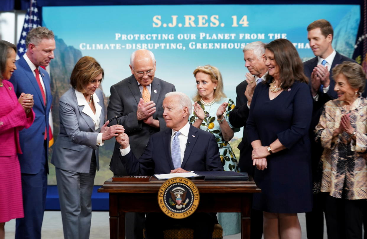 President Biden, with House Speaker Nancy Pelosi, after signing S.J.Res.14, a bill affecting emissions standards for oil and natural gas