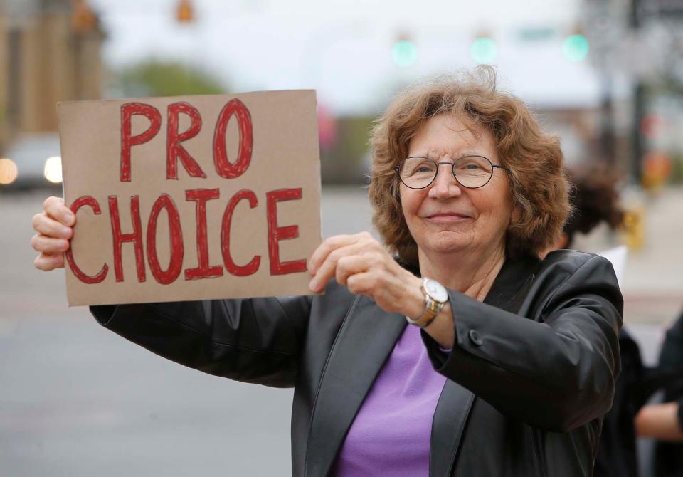 Jane Minner holds her "pro-choice" sign during a rally Tuesday in downtown Akron following the leaked U.S. Supreme Court decision that would reverse Roe V. Wade.