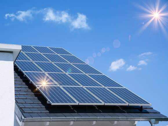 Roof with solar panels on a sunny day.