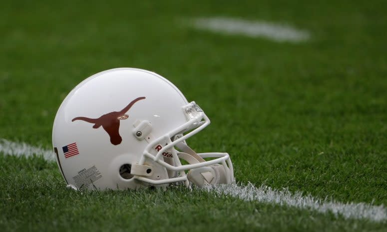 A Texas Longhorns football helmet sitting on the field.