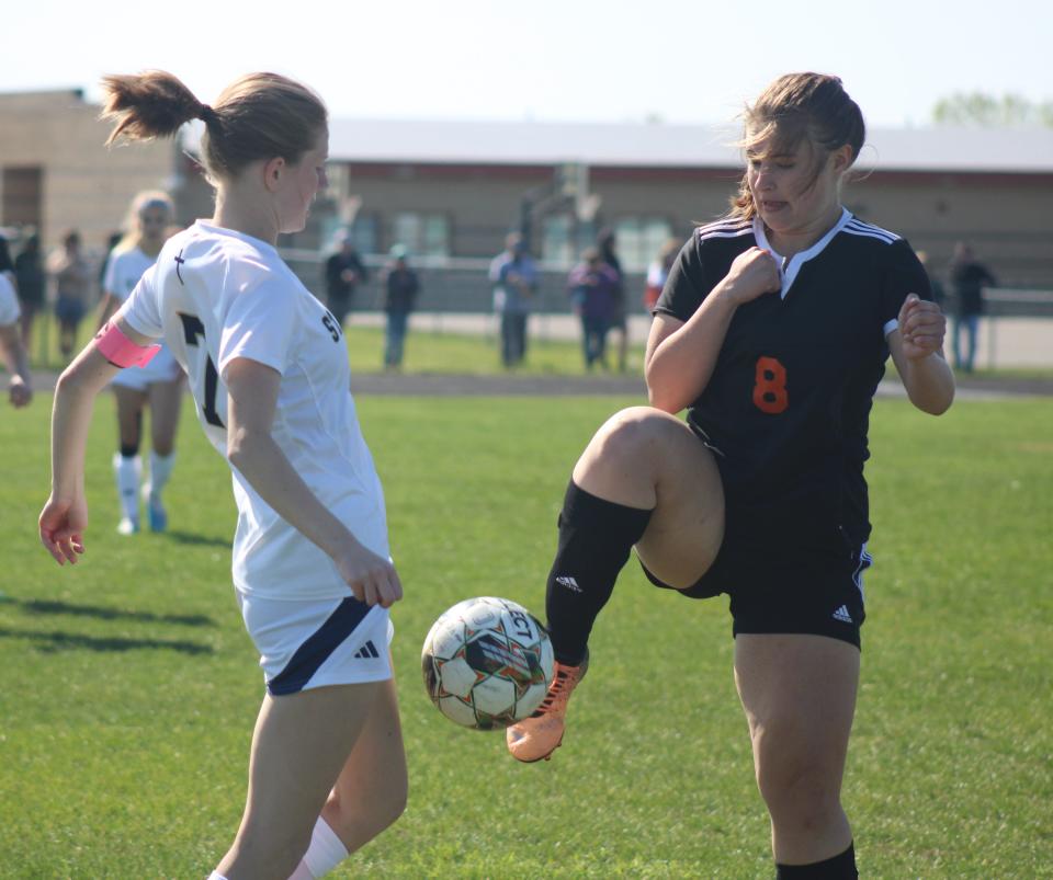 Cheboygan junior midfielder Bella Lail (8) and TC St. Francis' Sevilla Tarrant (7) battle for the ball during the first half on Thursday.