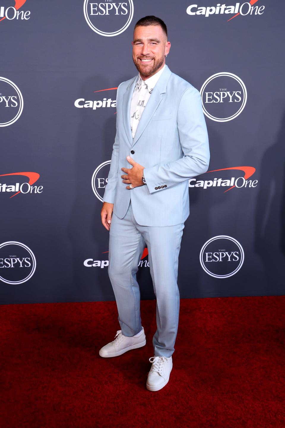 Travis Kelce wearing a powder blue suit over a patterned white button-up shirt.