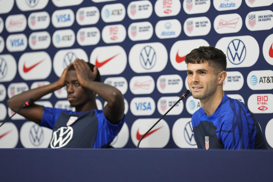 Tim Weah, left, and Christian Pulisic, both of the United States, attend a press conference before a training session at Al-Gharafa SC Stadium, in Doha, Thursday, Dec. 1, 2022. (AP Photo/Ashley Landis)