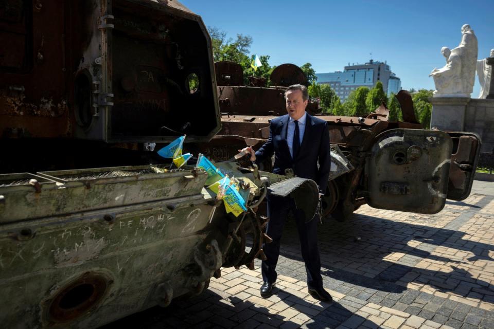 Foreign Secretary Lord David Cameron walks past a display of destroyed Russian military vehicles in Saint Michael’s Square, in Kyiv (AP)