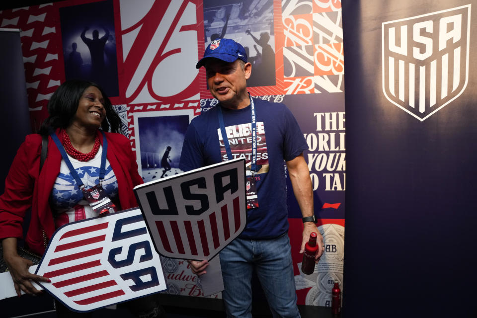 Kanikah Perry-Acosta and Ken Acosta, parents of United States midfielder Kellyn Acosta, prepare to pose for a photo during an official U.S. Soccer fan party at the FIFA World Club ahead of a group B soccer match between the United States and Wales, in Doha, Sunday, Nov. 20, 2022. (AP Photo/Ashley Landis)