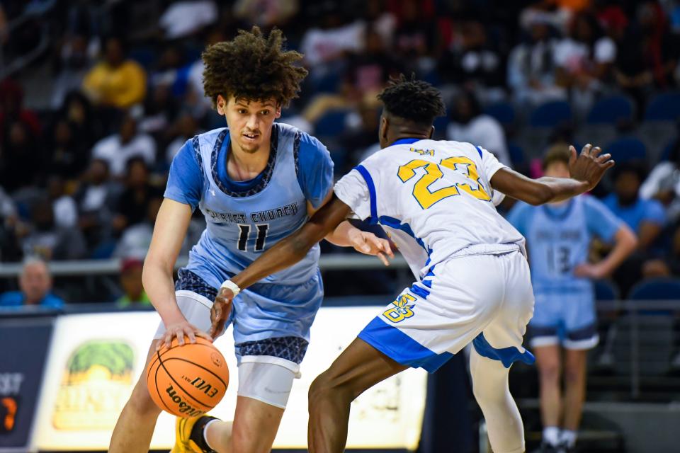 Christ Church's Jordan Butler (11) moves the ball past Scott's Branch's Emorej Stephens (23) during the Class A boys state basketball championship game that resulted in a 63-41 win for Christ Church at USC Aiken Convocation Center in Aiken, S.C., on Saturday, March 4, 2023.