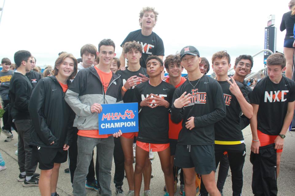 Northville celebrates its first state title in boys’ cross-country. The Mustangs had three all-state runners: Brendan Herger, Brady Heron and Ethan Powell.