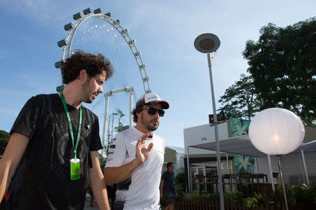 McLaren's Fernando Alonso of Spain (R) enters the Marina Bay Circuit ahead of the Singapore F1 Grand Prix Night Race in Singapore, September 15, 2016. REUTERS/Jeremy Lee