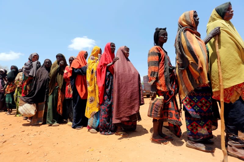 FILE PHOTO: Internally displaced Somali women queue for relief food at a distribution centre organized by a Qatar charity after fleeing from drought stricken regions in Baidoa, west of Somalia's capital Mogadishu