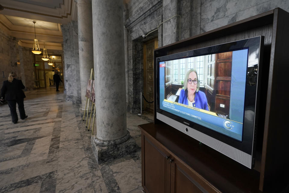 Catherine J. Ross, a professor of constitutional law at George Washington University Law School, is shown on a video monitor outside the Senate chamber as she testifies remotely at a committee hearing on a bill that would make it a gross misdemeanor for elected officials or candidates to knowingly lie about election outcomes if those claims result in violence, Friday, Jan. 28, 2022, at the Capitol in Olympia, Wash. Ross told the committee that she consulted on and helped craft the language of the bill. (AP Photo/Ted S. Warren)
