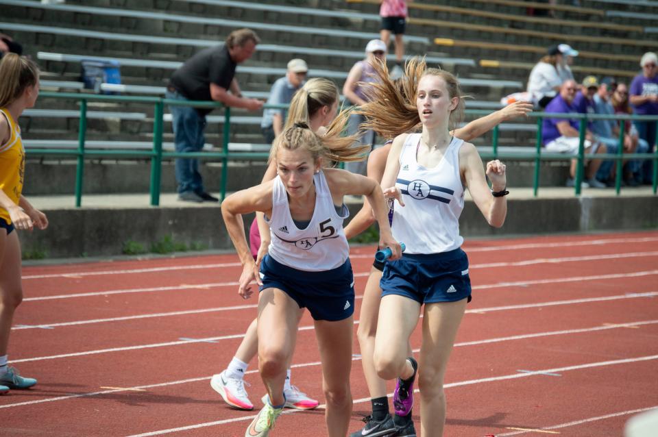 Anna Roberts receives the handoff from a teammate during the 4x400-meter relay