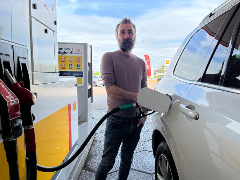 the writer's husband pumping gas