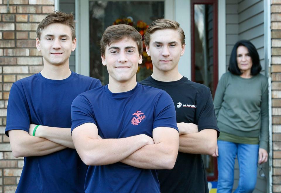 Matthew, Griffin and Connor Wehr have all enlisted in the U.S. Marine Corps and will enter after graduating from high school this spring. Mom Michelle is at right.