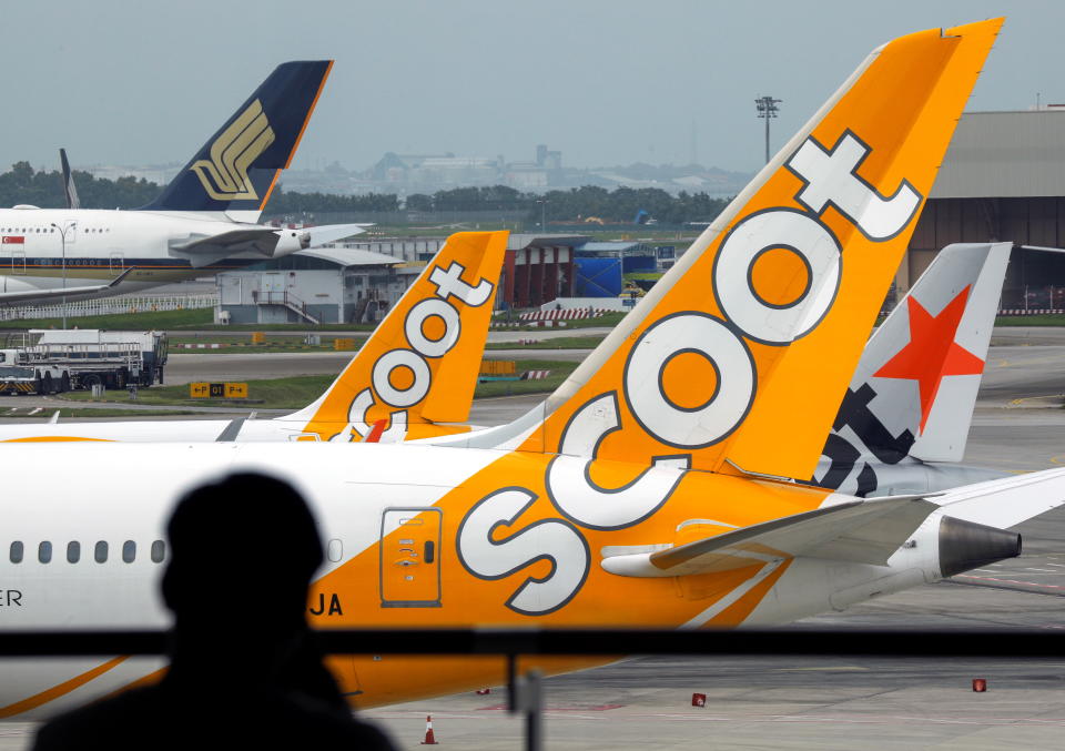 Scoot, Jetstar and Singapore Airlines planes sit on the tarmac at Singapore's Changi Airport, Singapore January 18, 2021. REUTERS/Edgar Su