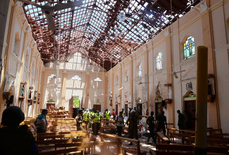 ATTENTION EDITORS - VISUAL COVERAGE OF SCENES OF DEATH AND INJURY Crime scene officials inspect the site of a bomb blast inside a church in Negombo, Sri Lanka April 21, 2019. REUTERS/Stringer