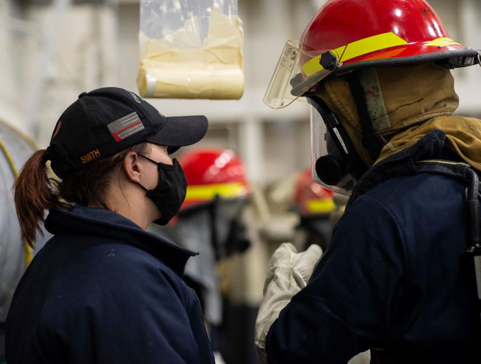 Hull Maintenance Technician 2nd Class Miranda Smith from Dracut, Mass., guides members of the de-smoking team during a fast cruise aboard the aircraft carrier USS Nimitz (CVN 68). The fast cruise consists of equipment tests, simulations, scenarios, which refresh and train Sailors for underway periods. Nimitz is currently undergoing a planned incremental availability maintenance period at Puget Sound Naval Shipyard.