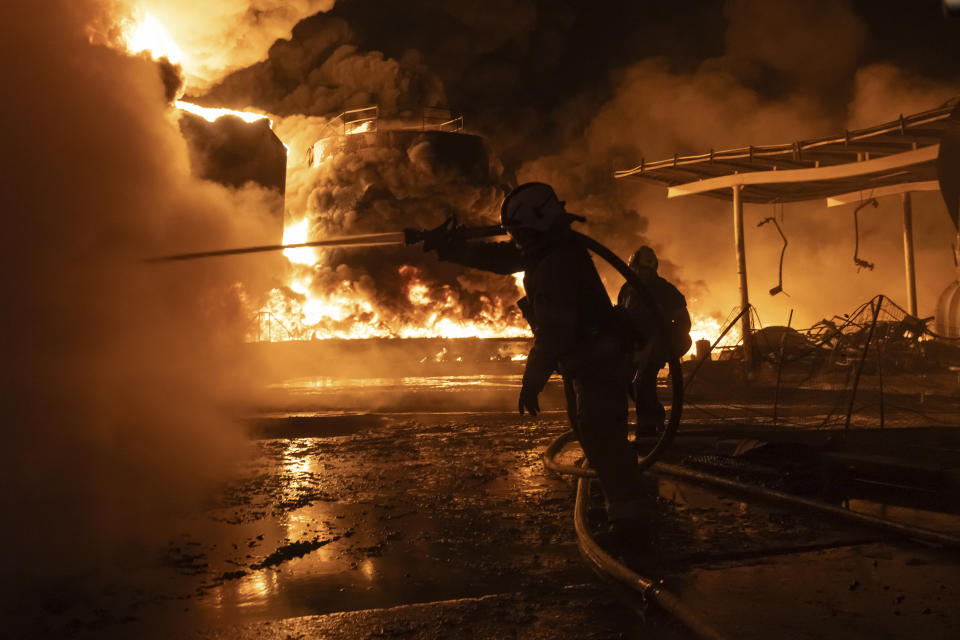 Firefighters extinguish a fire after a Russian attack on a residential neighborhood in Kharkiv, Ukraine Saturday, Feb. 10, 2024. (AP Photo/Yevhen Titov)