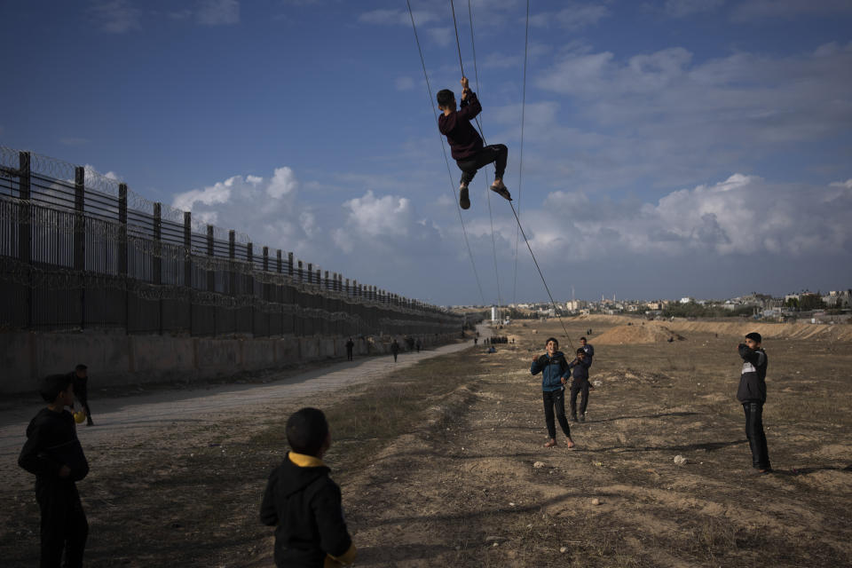 Palestinians displaced by the Israeli bombardment of the northern Gaza Strip play next to the border with Egypt, in Rafah, southern Gaza, Sunday, Jan. 14, 2024. (AP Photo/Fatima Shbair, File)