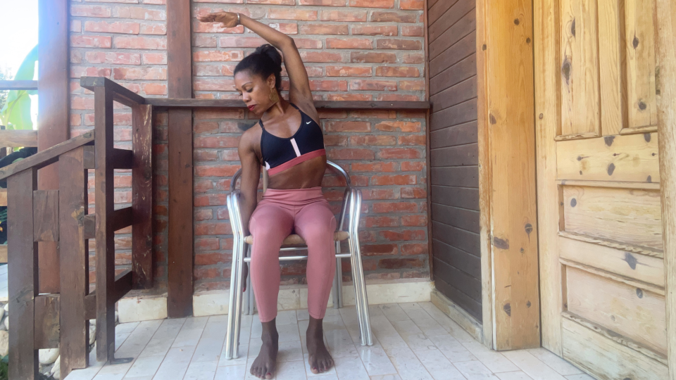 Aysha Bell doing a seated side stretch