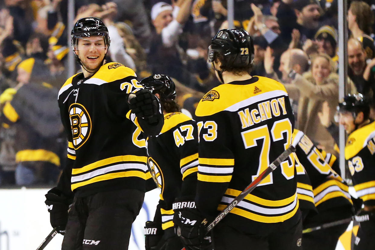 BOSTON, MA - DECEMBER 21: Charlie McAvoy #73 of the Boston Bruins celebrates Brandon Carlo #25 after scoring the game winning goal during a shoot out against the Winnipeg Jets at TD Garden on December 21, 2017 in Boston, Massachusetts. The Bruins defeat the Jets 2-1 in a shoot out. (Photo by Maddie Meyer/Getty Images)
