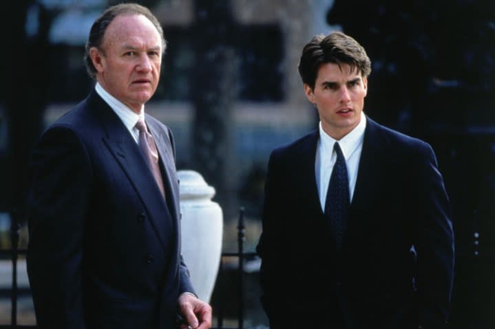 Two men in suits stand next to each other in The Firm.