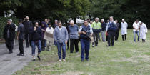 Police escort witnesses away from a mosque in central Christchurch, New Zealand, Friday, March 15, 2019. Multiple people were killed in mass shootings at two mosques full of people attending Friday prayers, as New Zealand police warned people to stay indoors as they tried to determine if more than one gunman was involved. (AP Photo/Mark Baker)