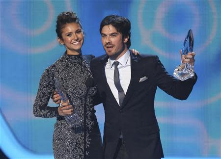 Nina Dobrev and Ian Somerhalder accept the award for favorite on-screen chemistry for their show "The Vampire Diaries" at the 2014 People's Choice Awards in Los Angeles, California January 8, 2014. REUTERS/Mario Anzuoni