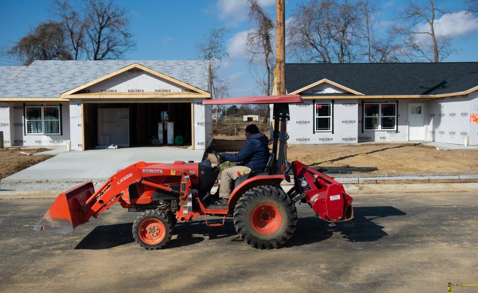 Mark Stone of Hugh Stone and Sons Construction drives a Front End Loader past a group of homes under construction in the development Canoe Creek ll in Henderson, KY.,  Wednesday morning, Nov. 16, 2022. Stone and his brother Chris Stone have secured 20 permits to build new single family homes in Henderson since 2020.