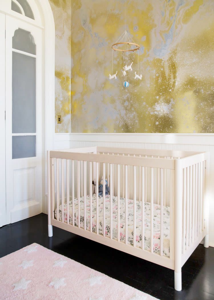 <p>Use a contemporary wallpaper with a metallic sheen for a dreamy. ethereal feel. In this nursery designed by <a href="https://thewhitearrow.com/" rel="nofollow noopener" target="_blank" data-ylk="slk:White Arrow,;elm:context_link;itc:0;sec:content-canvas" class="link ">White Arrow,</a> the abstract Calico Wallpaper will still add some beauty and style no matter how the space is used in the future. </p>