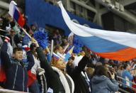 A Russian fan celebrates a goal during the third period of the game against Germany at the 2014 Winter Olympics women's ice hockey game at Shayba Arena, Sunday, Feb. 9, 2014, in Sochi, Russia. (AP Photo/Petr David Josek)