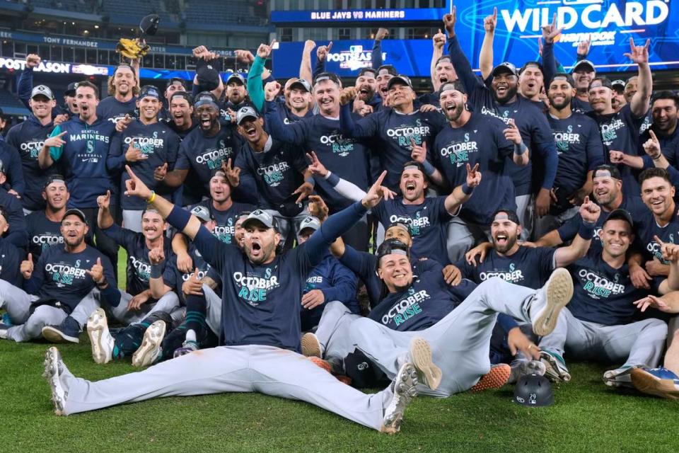 Seattle Mariners celebrate their win over the Toronto Blue Jays in Game 2 of a baseball AL wild-card playoff series Saturday, Oct. 8, 2022, in Toronto. The Mariners advanced to the AL Division Series.