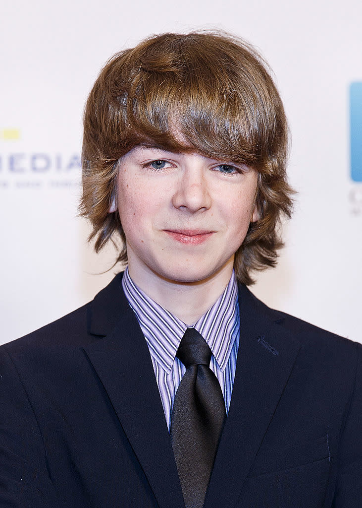 Ryan Grantham in a suit with striped tie at an event.