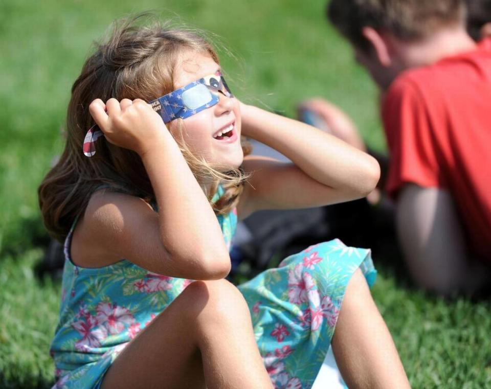Trinity Carson looks at the on Aug. 21, 2017 solar eclipse at The Arboretum at Penn State.