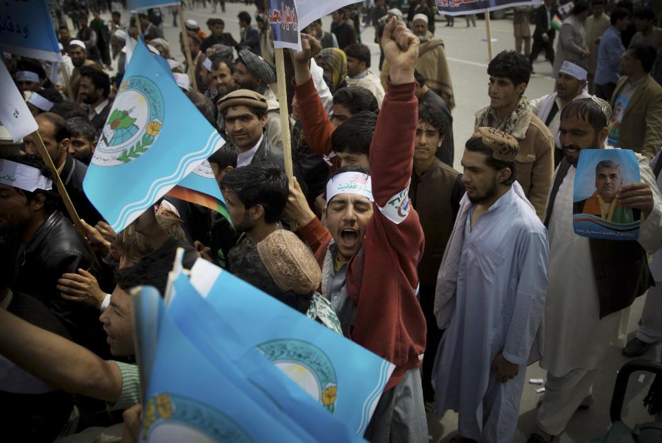 An Afghan man shouts in support for presidential candidate Ashraf Ghani Ahmadza as he arrives with others for an election campaign rally to the stadium in Kabul, Afghanistan, Tuesday, April 1, 2014. Elections will take place on April 5, 2014. (AP Photo/Anja Niedringhaus)