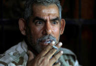 <p>An Iraqi soldier from 9th Armoured Division smokes a cigarette inside a house that has become their temporary advance command post in the Shifa neighbourhood in western Mosul, Iraq, June 15, 2017. (Photo: Erik De Castro/Reuters) </p>