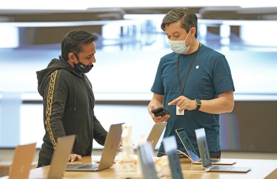 A customer in the Apple Store in Regent Street, central London, as the new iPhone 13 goes on sale (Kirsty O’Connor/PA) (PA Wire)