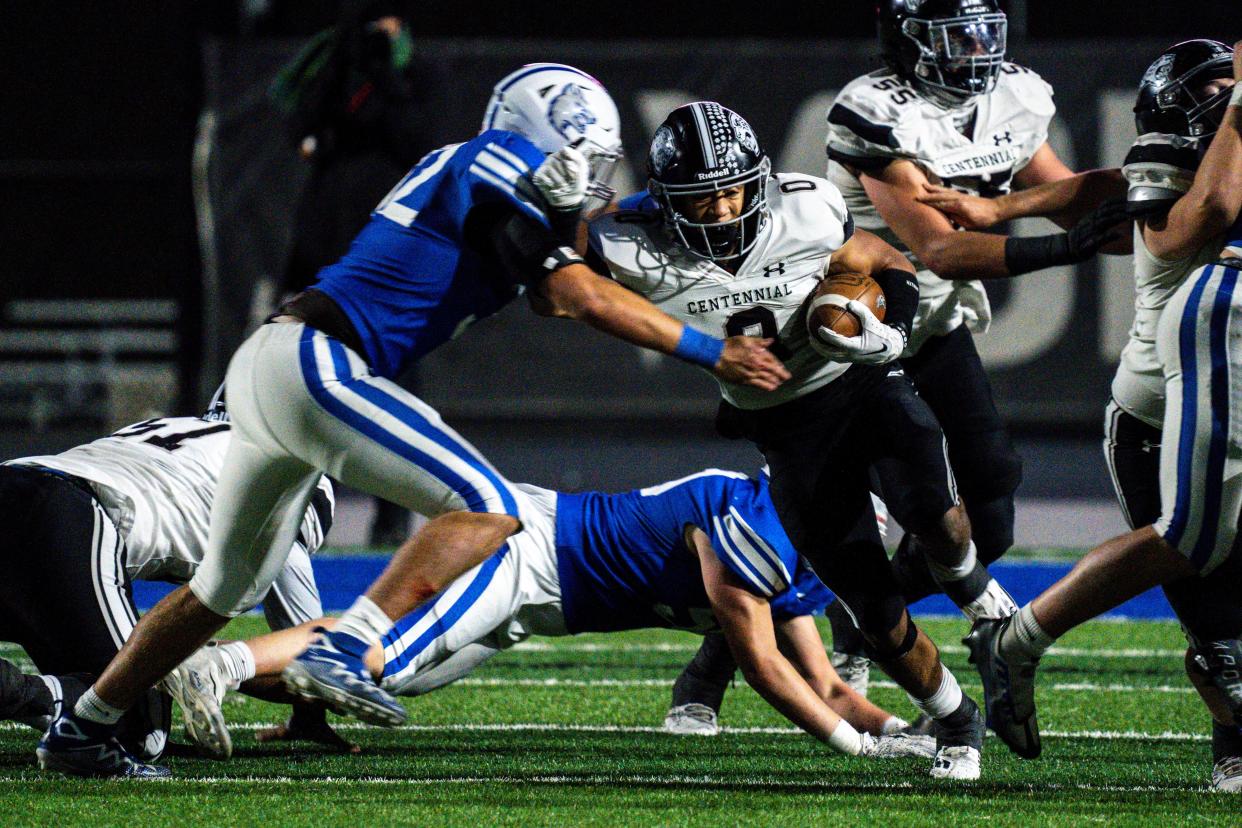 Ankeny Centennial's Elijah Porter breaks through tackles from Waukee Northwest defense during the first round of playoff football on October 27, 2023. Porter is one of the elite high school football prospects competing at the Drake Relays this week.