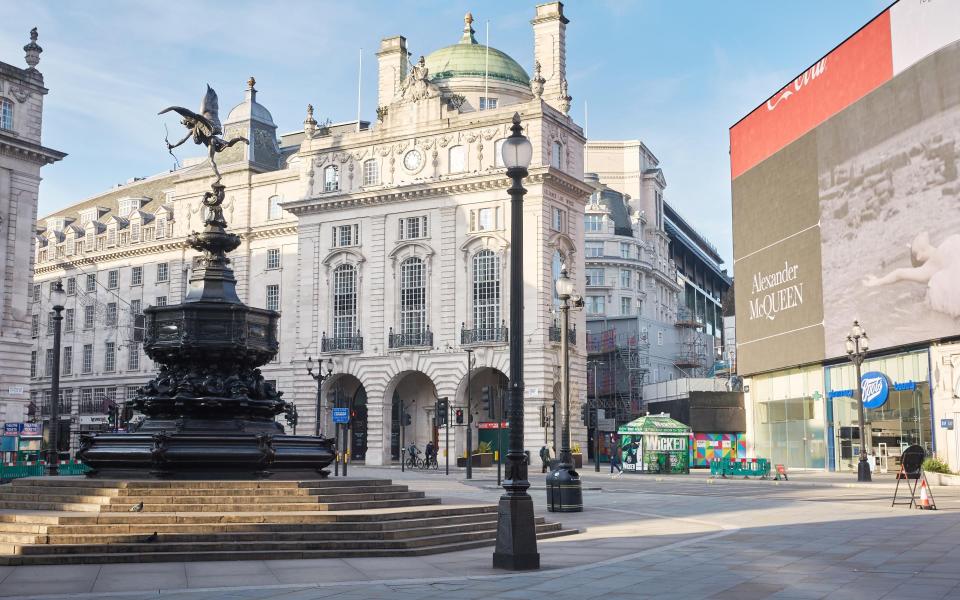 Piccadilly Circus, usually littered with tourists, stands empty at the start of the latest lockdown - Getty