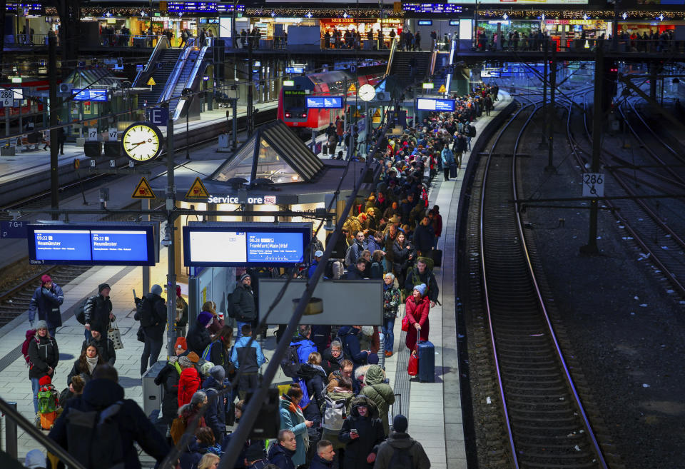 Numerous travelers wait for their train on a full platform at the main station in Hamburg, Germany, Friday Dec. 22, 2023. Pre-Christmas rail travelers in parts of Germany faced widespread disruption on Friday as a storm swept across northern Europe, bringing down trees and prompting warnings of flooding on the North Sea coast. (Christian Charisius/dpa via AP)