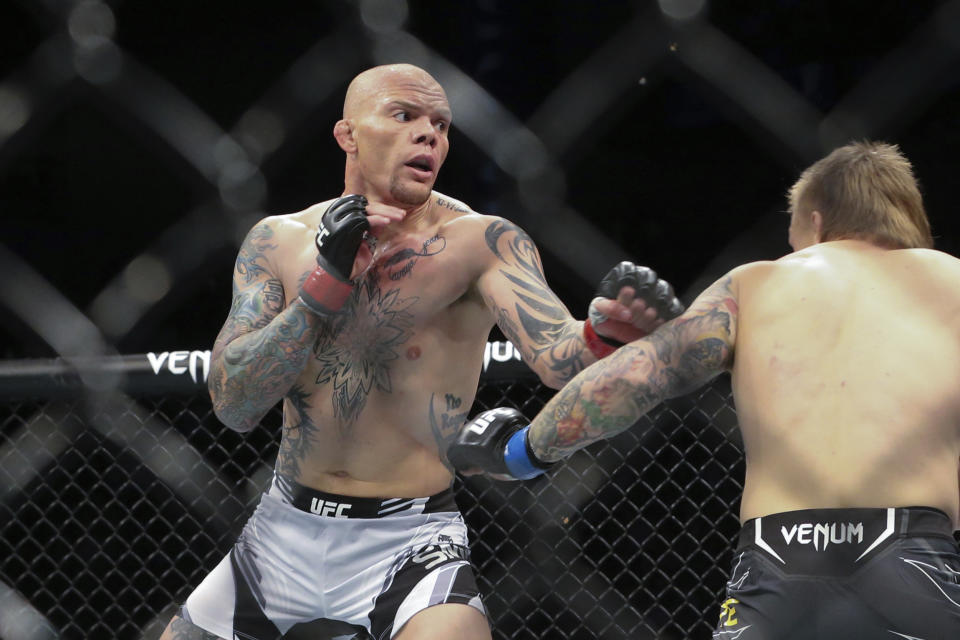 Anthony Smith, left, looks for an opening to hit Jimmy Crute during a UFC 261 mixed martial arts bout, Saturday, April 24, 2021, in Jacksonville, Fla. It is the first UFC event since the onset of the COVID-19 pandemic to feature a full crowd in attendance. (AP Photo/Gary McCullough)