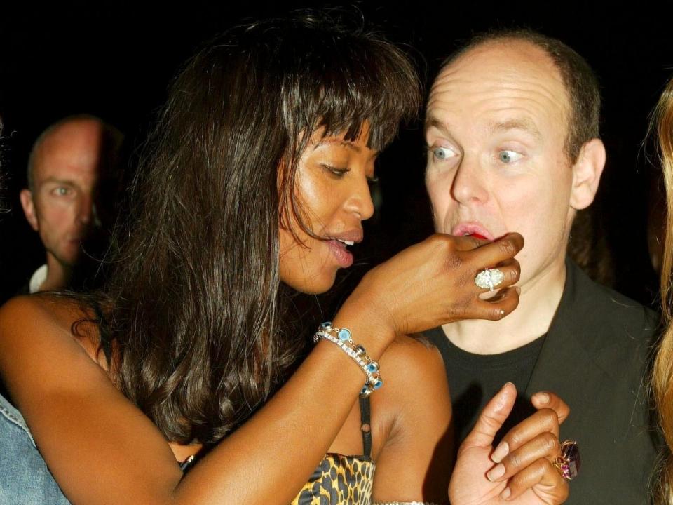 Naomi Campbell  feeding Prince Albert with her hands