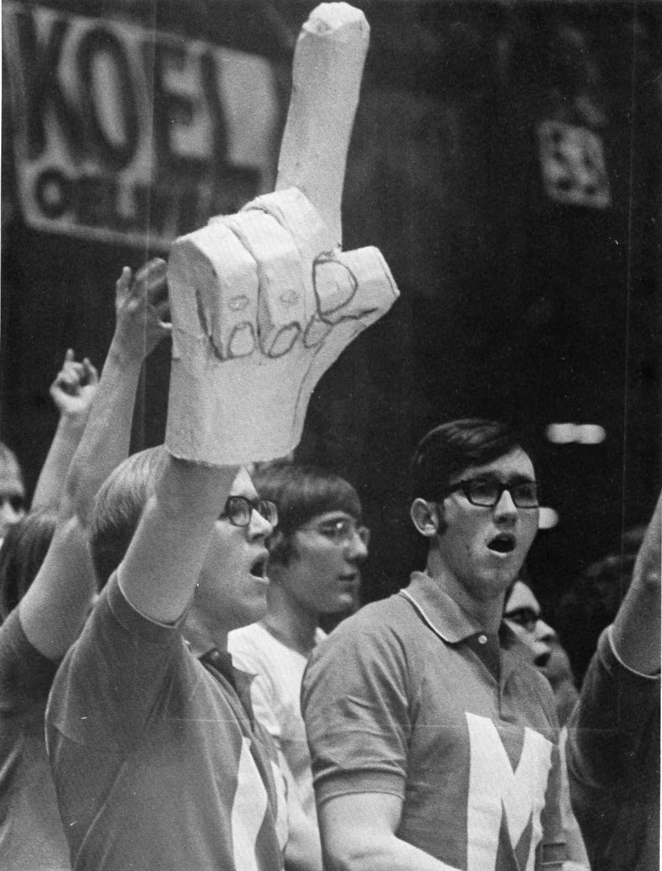 Foam finger creator Steve Chmelar brought his homemade creation to the Iowa High School Athletic Association’s boys state basketball finals in 1971. The Associated Press snapped a photo of him, which appeared in the <em>Des Moines Tribune</em>, and the No. 1 hand, better known as the foam finger, was born. (Courtesy of Steve Chmelar)