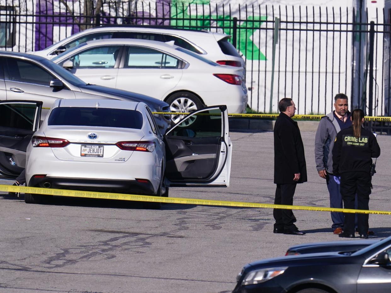 Authorities confer at the scene where multiple people were shot at the FedEx Ground facility early Friday morning, April 16, 2021, in Indianapolis. A gunman killed eight people and wounded several others before apparently taking his own life in a late-night attack at a FedEx facility near the Indianapolis airport, police said, in the latest in a spate of mass shootings in the United States after a relative lull during the pandemic. (AP Photo/Michael Conroy)