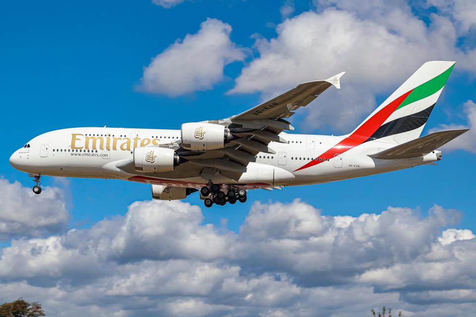 Emirates Airbus A380 aircraft as seen flying on final approach to Heathrow Airport during a blue sky summer sunny day with some clouds,