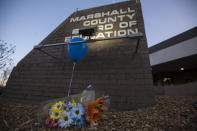 <p>A bouquet of flowers and balloon sit below a sign outside the Marshall County Board of Education in Benton, Ky., Wednesday, Jan 24, 2018. (Photo: Ryan Hermens/The Paducah Sun via AP) </p>