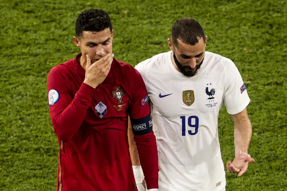 Cristiano Ronaldo (pictured left) and Karim Benzema (pictured right) talk as they leave the pitch together.